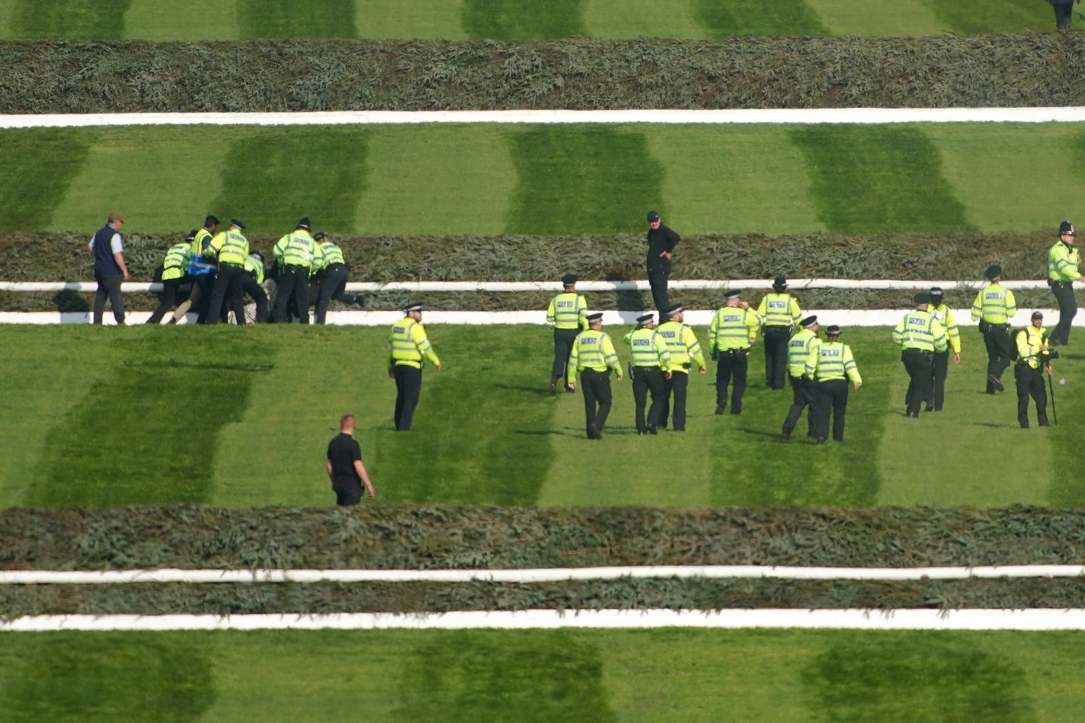 More than 100 arrested after protesters storm Grand National and delay race 